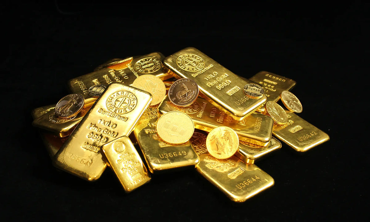 A pile of gold bullion bars and gold coins on a solid black background.