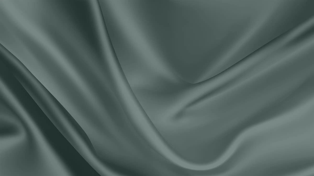 A close-up of draped satin fabric with soft folds and a smooth, lustrous texture in a muted sage green color.